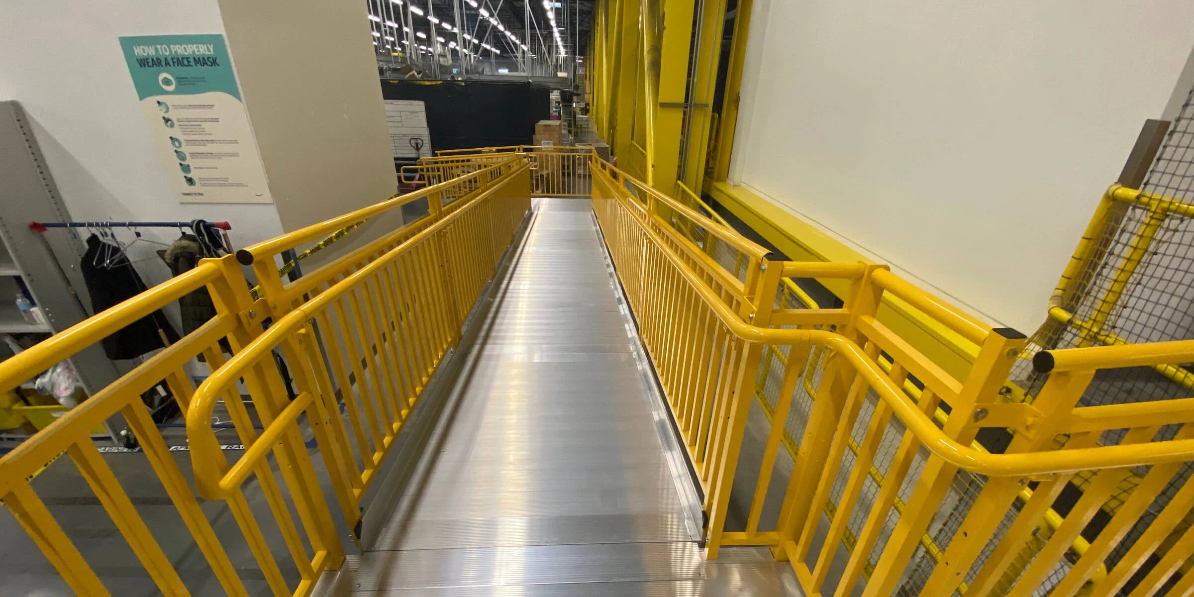 Warehouse Ramp with custom safety yellow handrail.